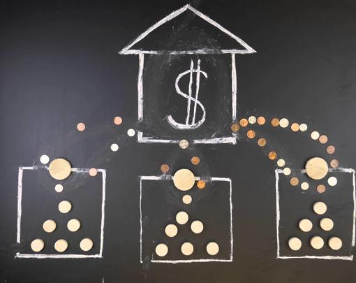 A picture of money moving schematically on a chalkboard to indicate the concentration of wealth in a financial institution.