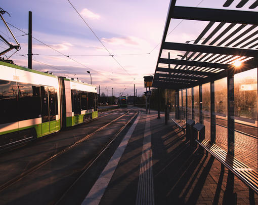 A modern light rail train at a station