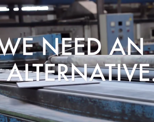"We Need An Alternative", on top of an image of a factory.