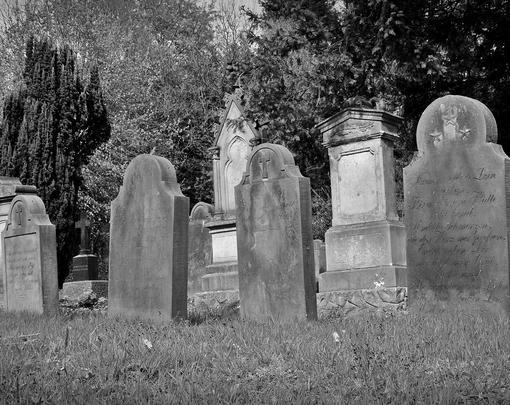 Black and white picture of tombstones in a cemetery
