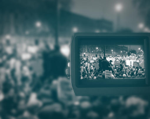 a clear image of a protest is scene through the lens of a camera