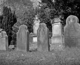 Black and white picture of tombstones in a cemetery