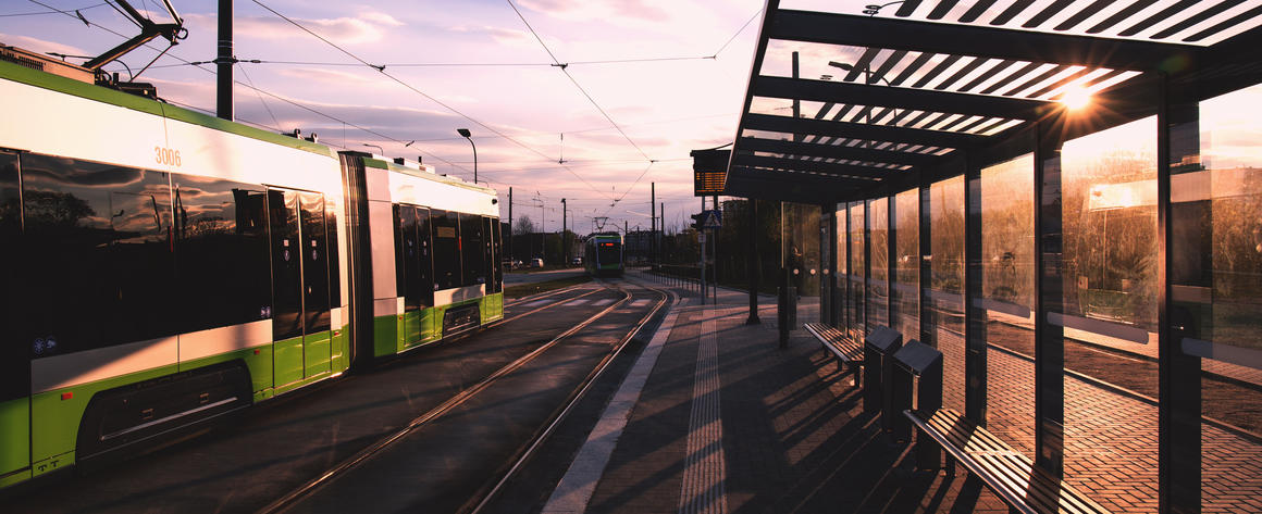 A modern light rail train at a station